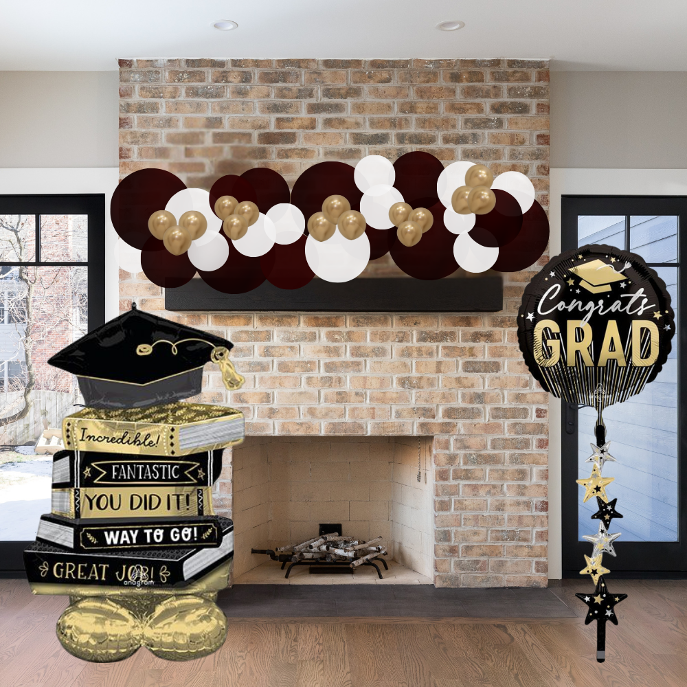Graduation-themed decorations including balloons and a banner in front of a fireplace.